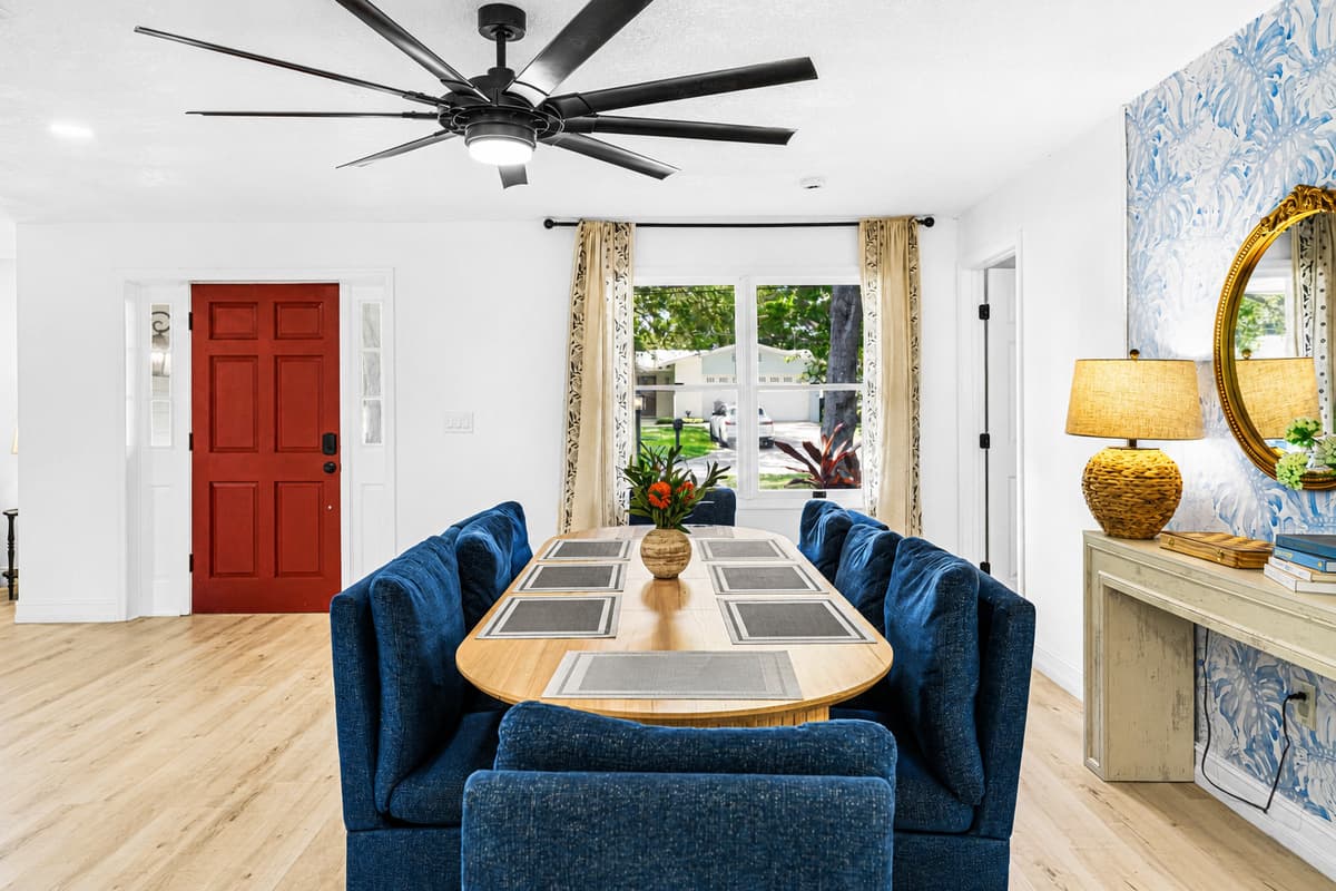 The first room past the front door: table set, lamp on, chairs already pulled out. You're expected.