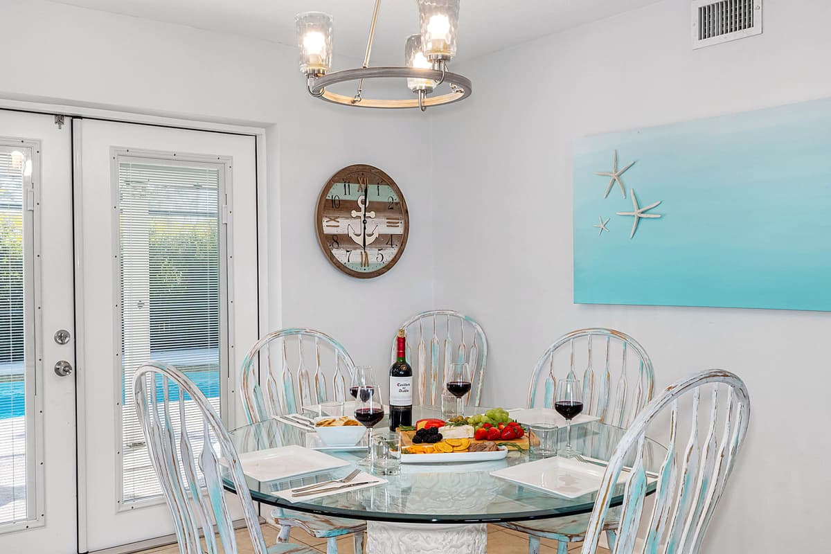 The main dining area features a beautifully crafted six-seater round dining table, perfect for gathering with family and friends.