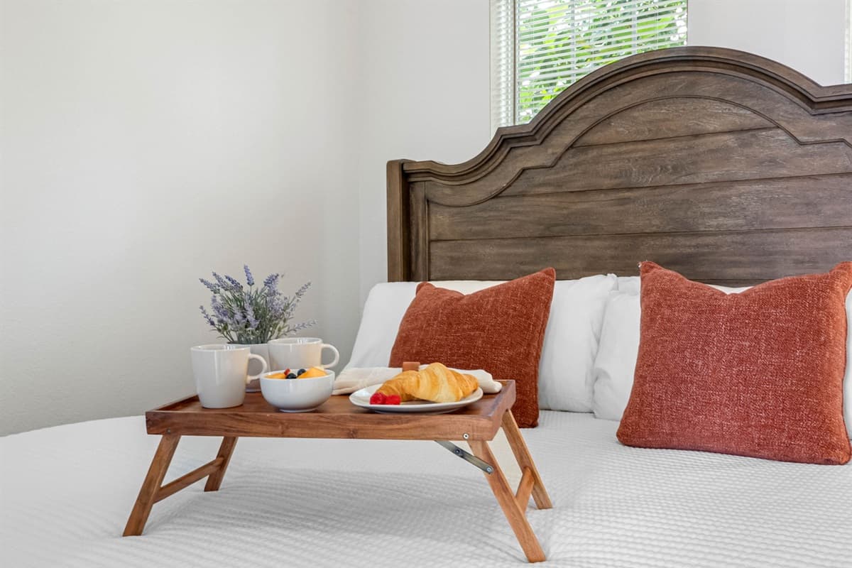 Enjoy a peaceful night’s sleep in this bright bedroom with large windows, modern finishes, and thoughtfully curated décor.