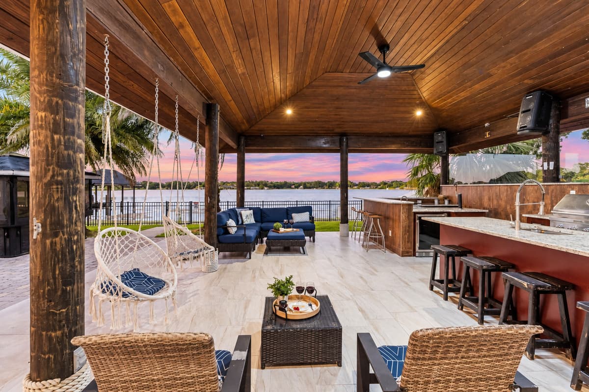 Swing gently in hammock chairs or sip wine on plush outdoor couches as the pink and purple sky reflects off the water.