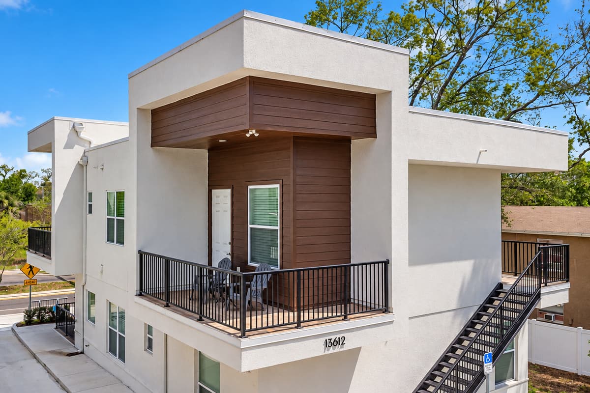 Brand new from the ground up. Built in 2025 with a clean white stucco facade, warm wood paneling, and an exterior staircase up to your 2nd-floor entrance. No dated hallways, no creaky floors. Everything here is new.