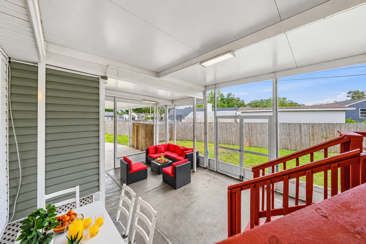 Elevated view of the spacious screened patio with comfortable seating and backyard views.