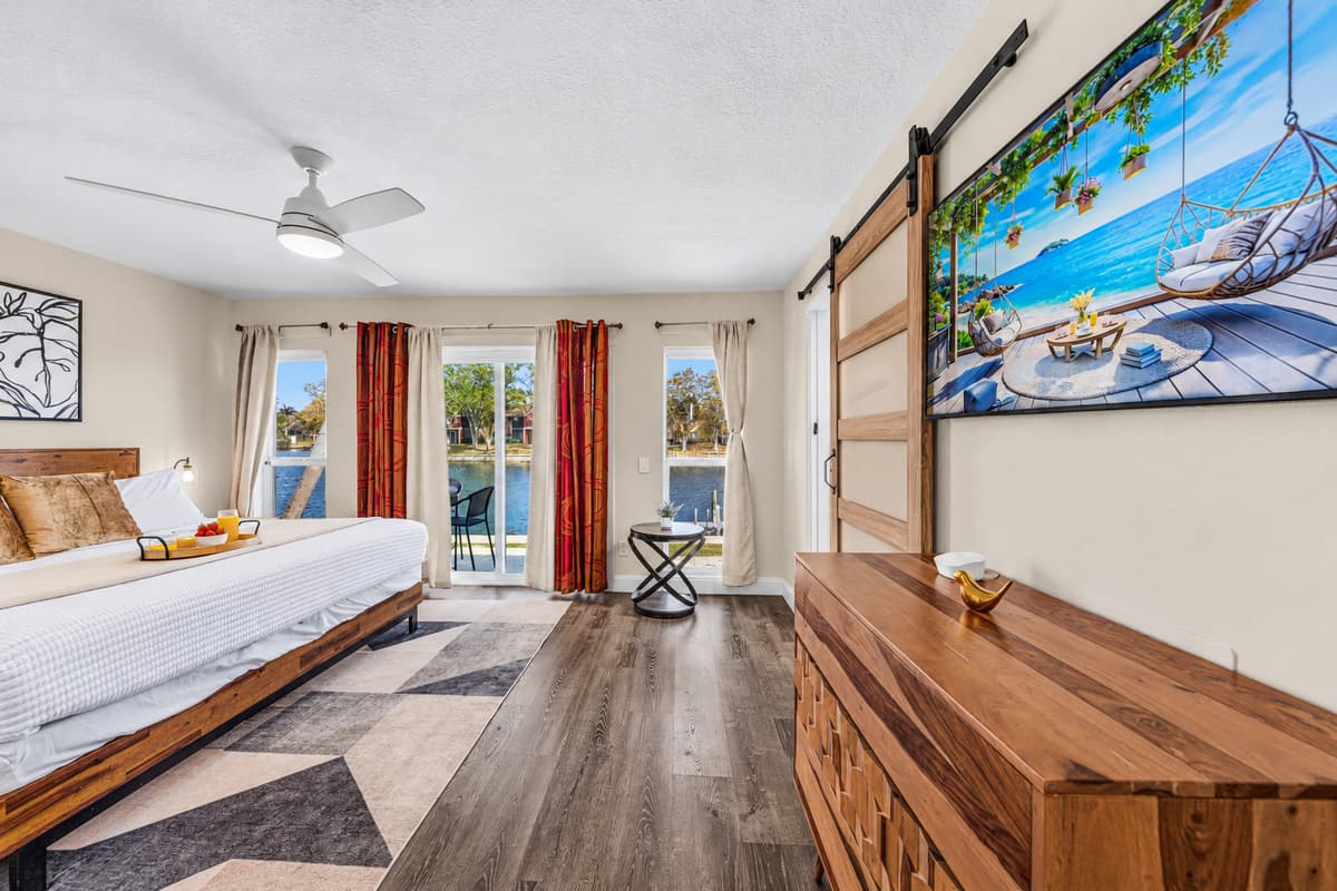 Large primary suite with Smart TV, queen bed, and direct access to the patio.