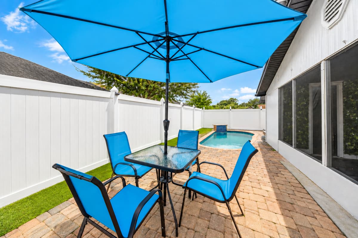 Outdoor dining area beside the pool, perfect for morning coffee, al fresco meals, and enjoying Tampa's beautiful weather.