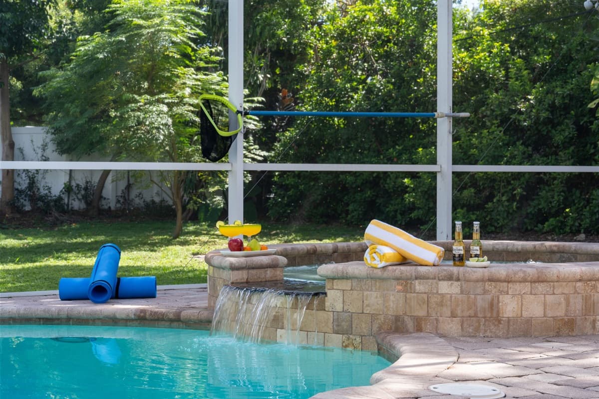 Resort-style screened pool area with ample space for lounging, swimming, and entertaining.