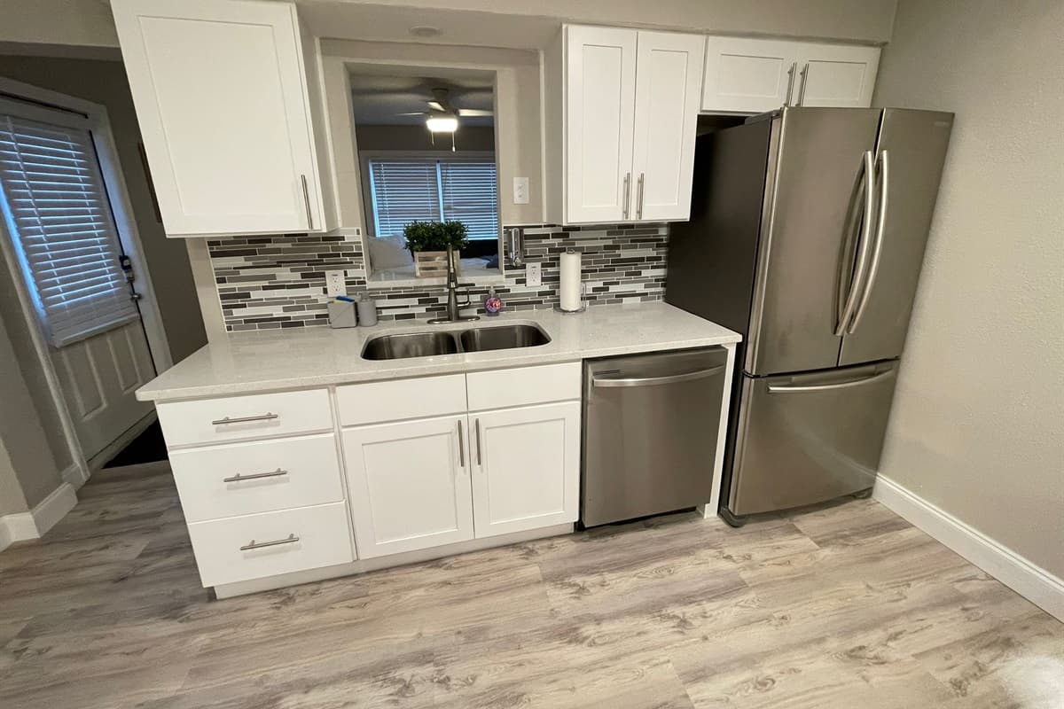 The open layout seamlessly integrates the kitchen with the dining area, creating a warm and inviting space perfect for entertaining guests or enjoying family meals.