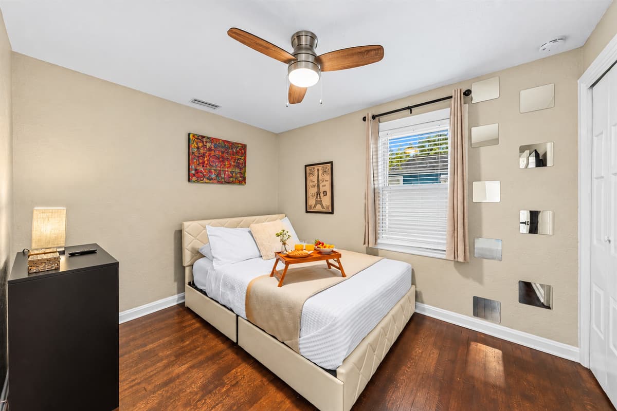 Stylish bedroom with plush bedding, modern décor, and warm natural lighting.
