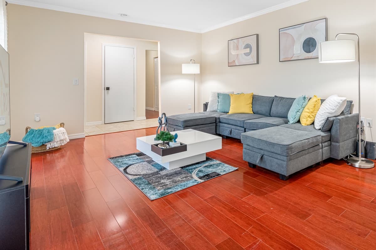 This living room is the epitome of cozy and chic, with plush sofas and chairs that invite you to sink in and relax.