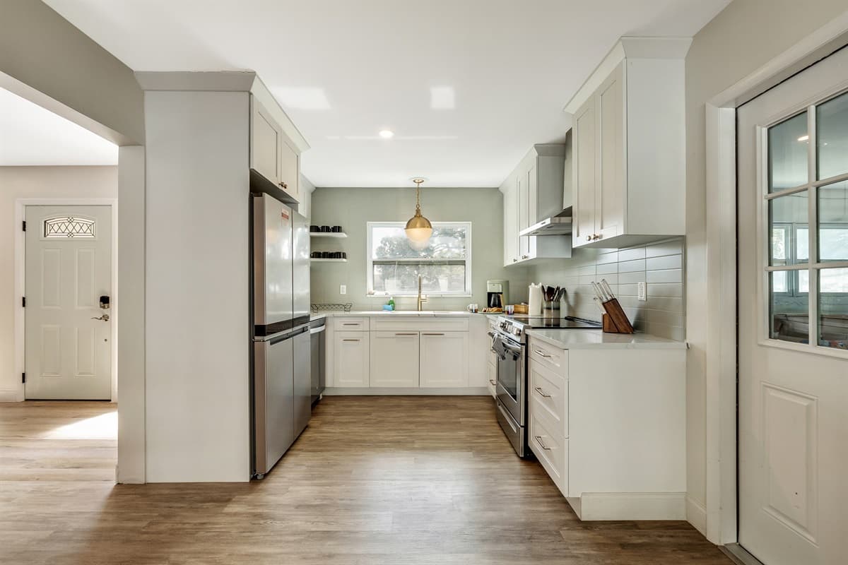 The kitchen is equipped with state-of-the-art appliances that blend seamlessly into the overall design.