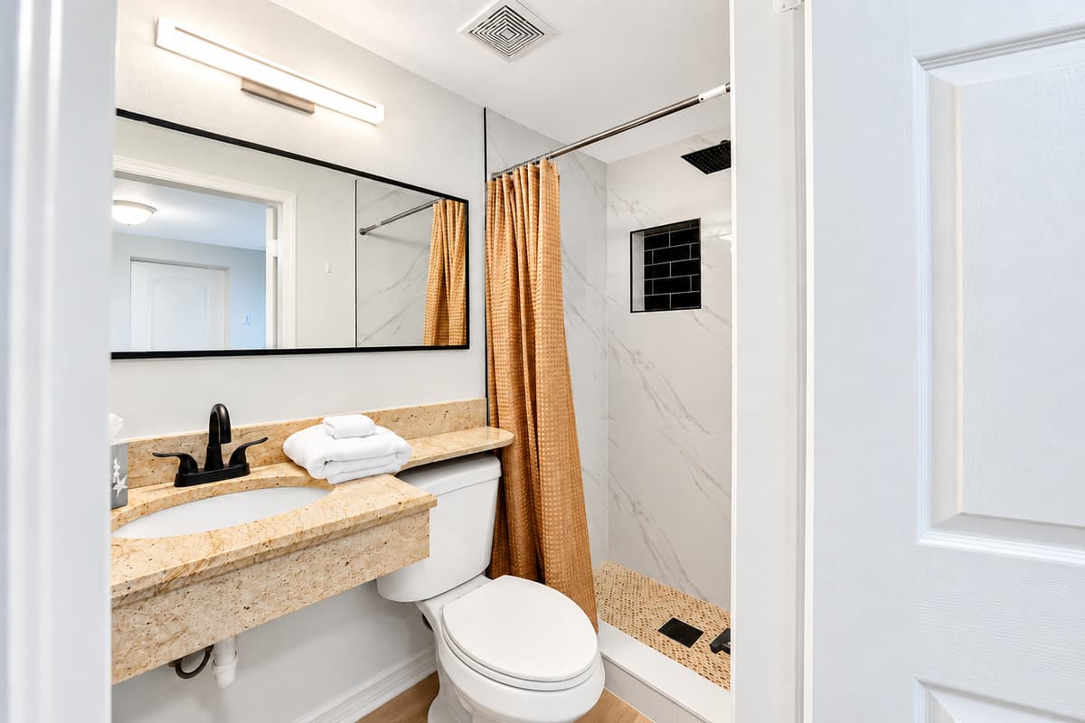 Bedroom 2 - Ensuite
Private ensuite bathroom connected to the family suite, offering a vanity, shower, and convenient access for guests.