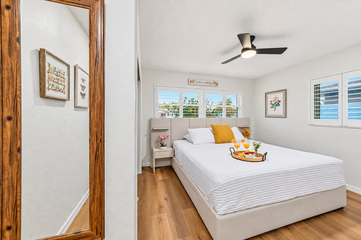 Bedroom view reflected through a full-length mirror, showcasing the clean and modern design 
