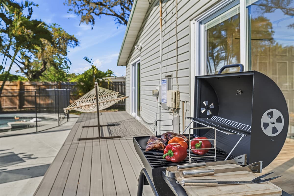 Backyard deck with grill, perfect for outdoor cooking and entertaining.