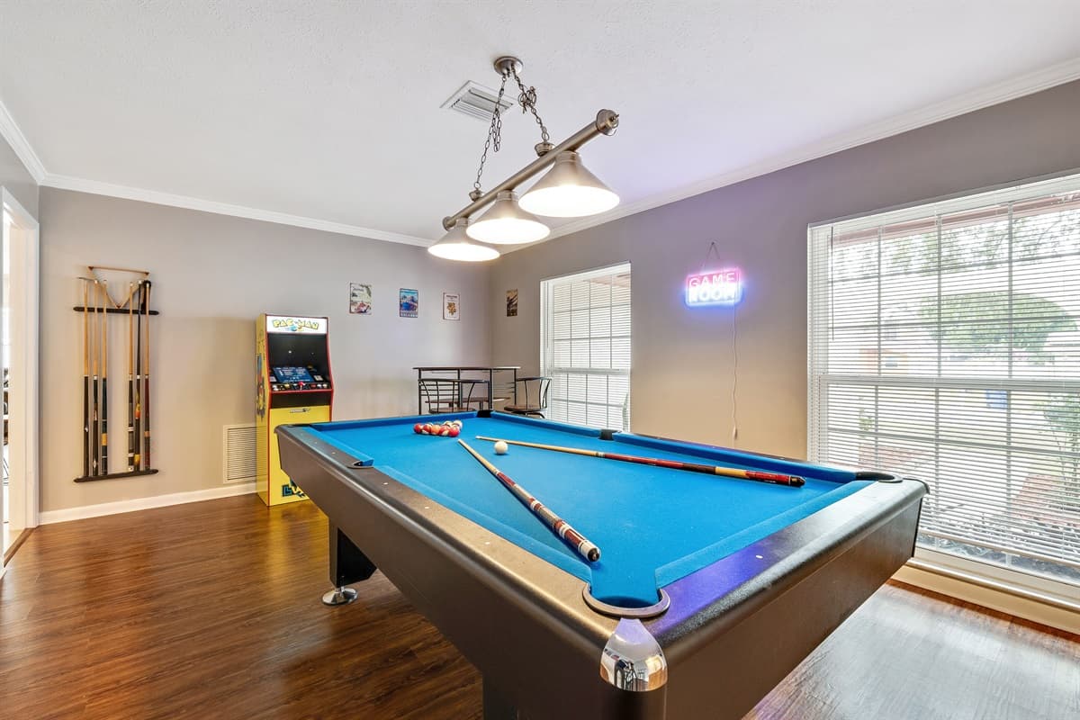 Adjacent to the PAC MAN marvel is a meticulously crafted pool table, promising hours of spirited camaraderie and skillful play.