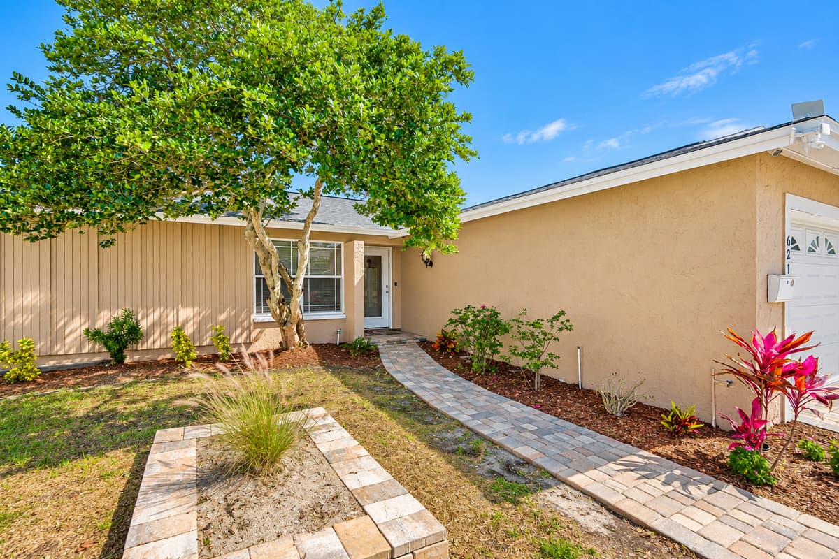 Beautifully maintained entryway of the property that has various beautiful plants on the side and a nice tree. Feel at home and relaxed while on your vacation! If you appreciate things like these, send us a message now!