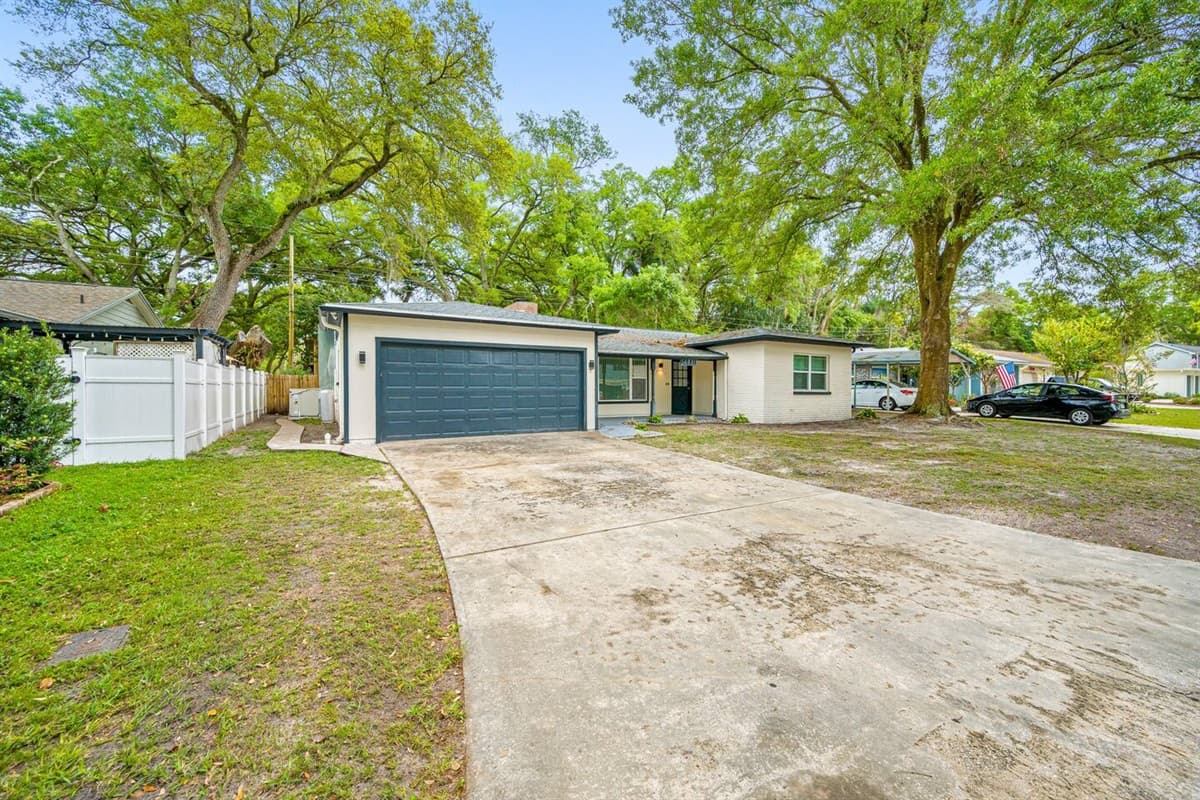 The left side area of the house showcasing the driveway to the garage. Never worry about where to park your cars. Don't hesitate to send us a message!