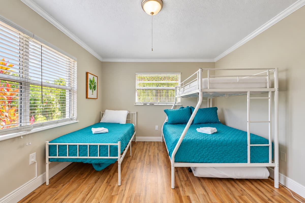Offering the convenience of a twin bed, a full-size bunk, and an additional free-standing twin bed.