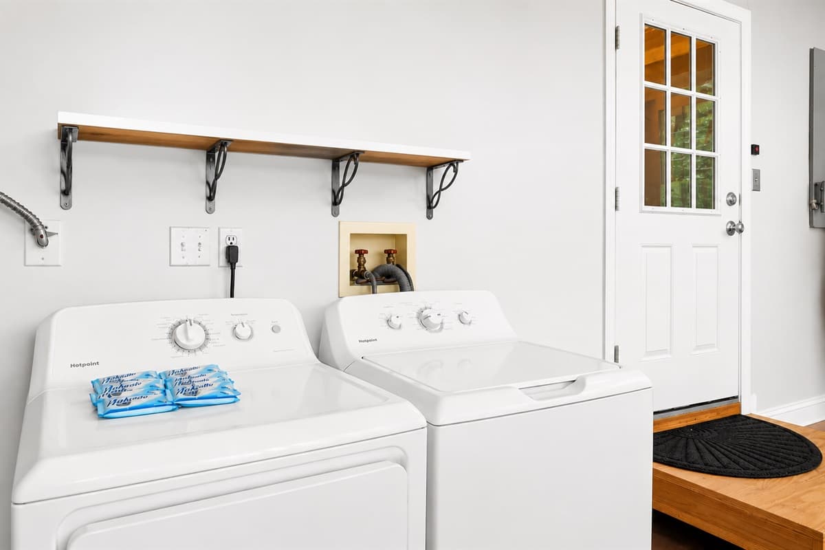 Convenient laundry area with full-size washer and dryer for guest use.