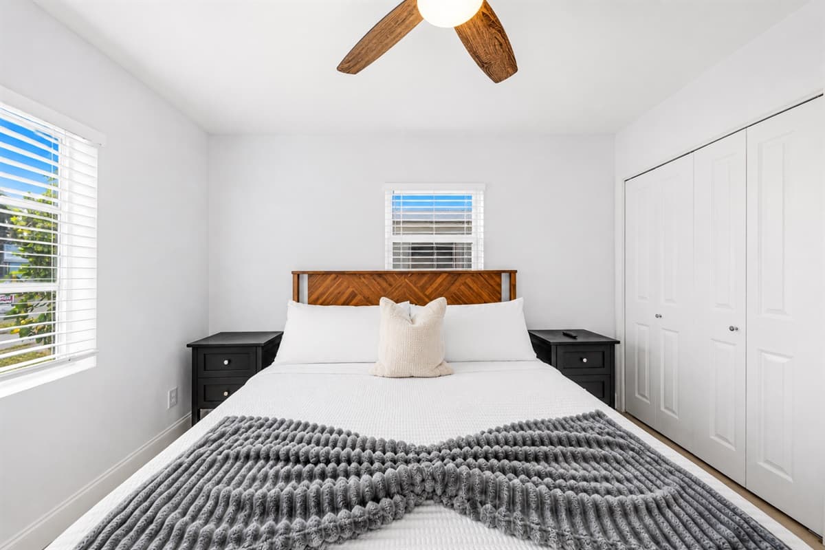 Inviting bedroom with modern décor, soft linens, and ample closet space.