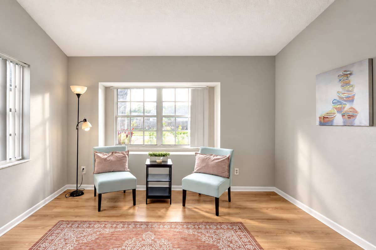 An aesthetically pleasing extra seating nook bathed in natural light by the window.