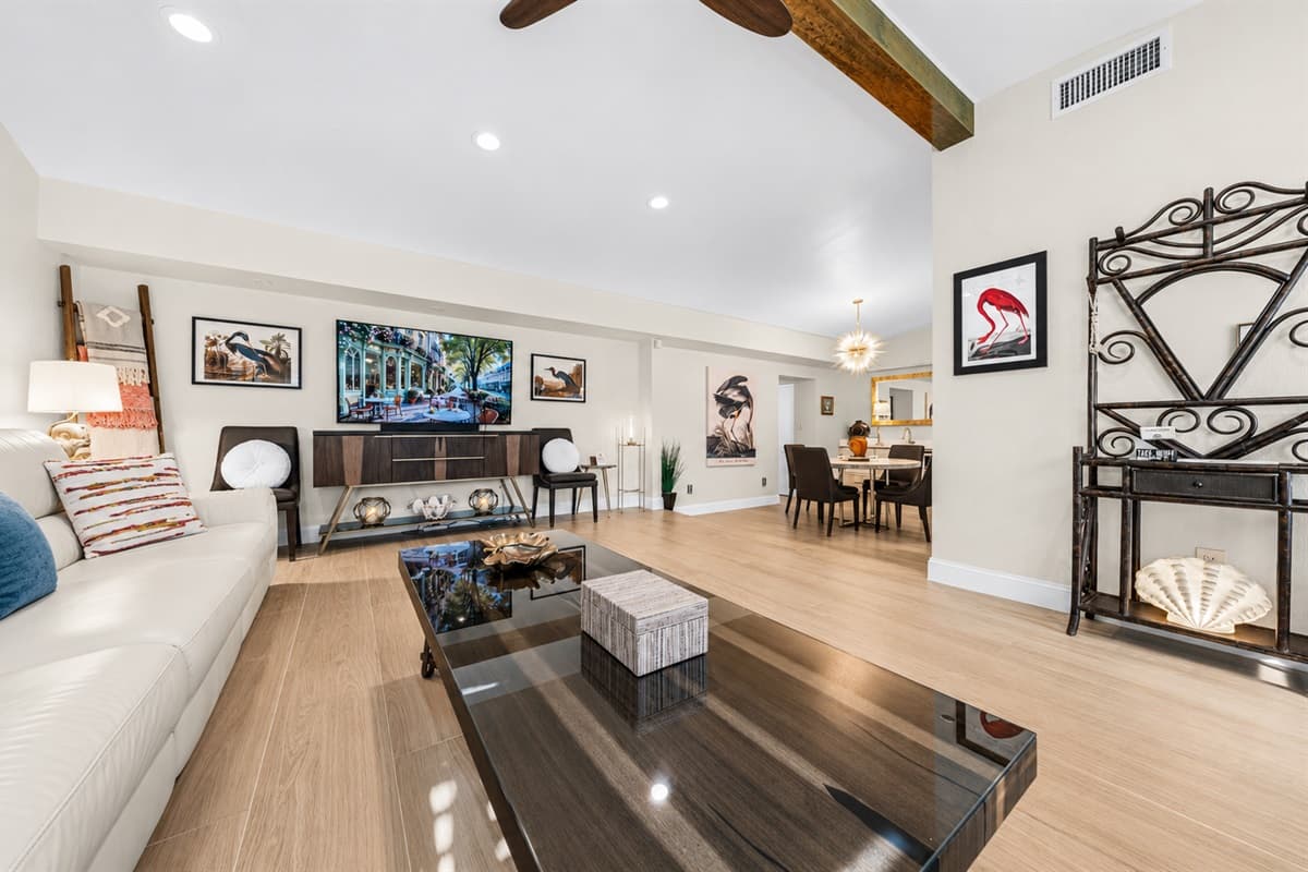 Spacious open-concept living area with oversized sectional sofa, vaulted ceilings, and stylish modern décor.