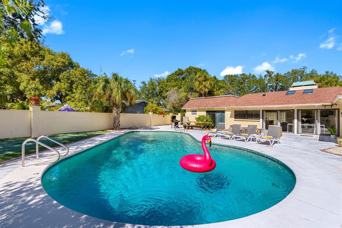 With lush landscaping, comfortable seating, and a crystal-clear pool, this outdoor space brings together relaxation and beauty in one spot.