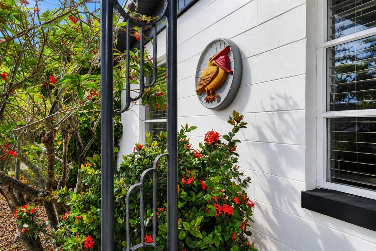 Beautiful landscaped entryway featuring colorful flowers and welcoming décor accents.