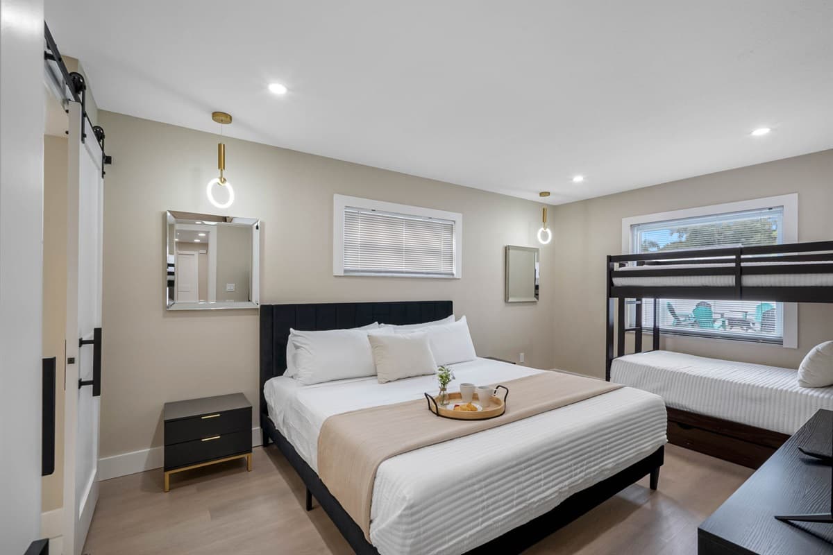 This primary suite features a king bed, twin-over-twin bunk, and a smart TV for cozy nights in.
