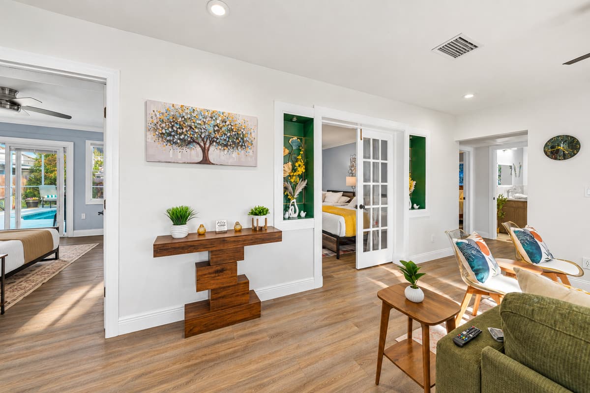 A bright and airy living room with tasteful accents, cozy seating, and a layout that encourages easy conversation and togetherness.