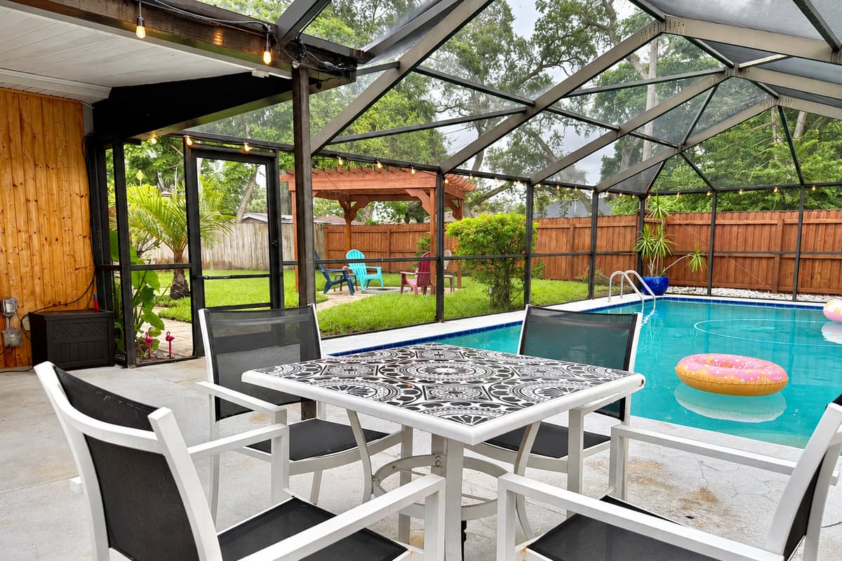 Enjoy meals, games, or morning coffee in this covered lanai just steps from the sparkling pool—bug-free and breezy!