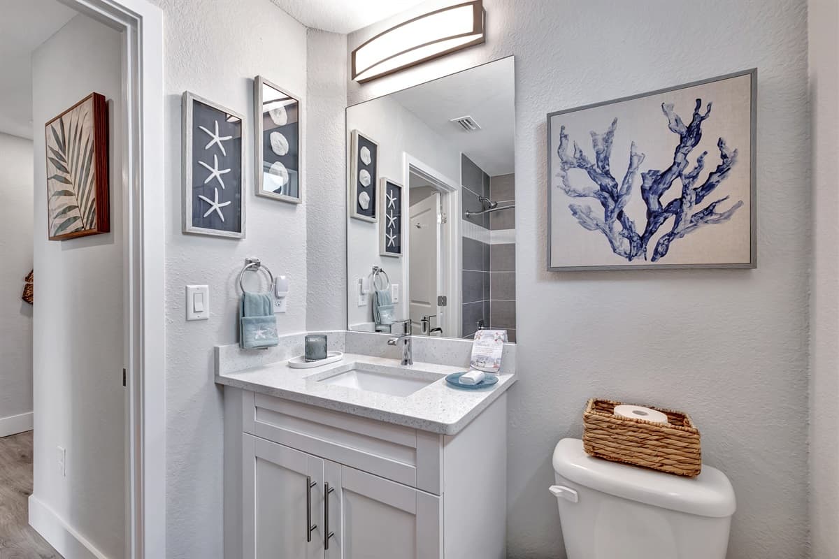 The sink vanity exudes a minimalistic charm, providing both storage and style.