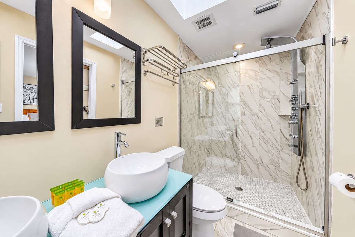 Spa-inspired bathroom featuring an oversized glass-enclosed walk-in shower.