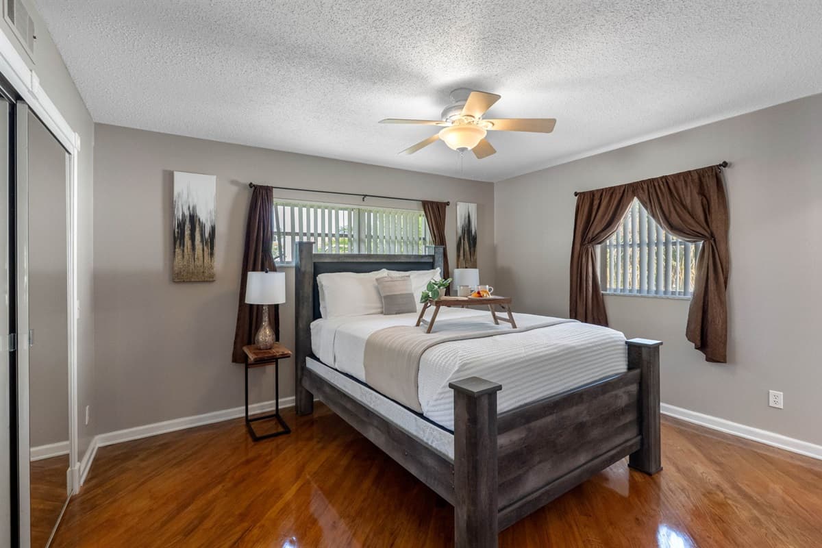 Complete with matching nightstands, dresser, and built-in lighting on the headboard, this bedroom combines function with comfort.