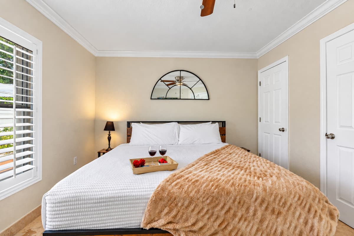 The wood-accented bed frame and earthy throw add rustic charm to this otherwise sleek and modern bedroom.