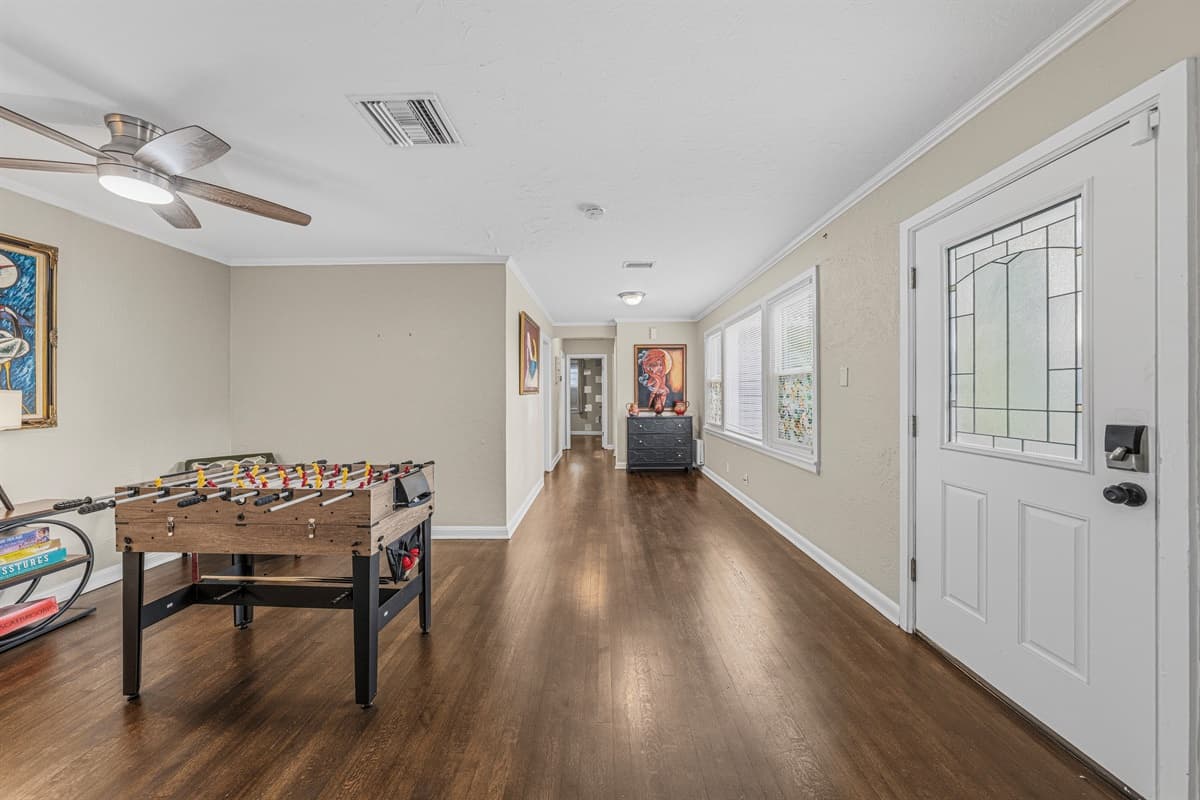 Long entertainment space with foosball table and plenty of room to relax or play.