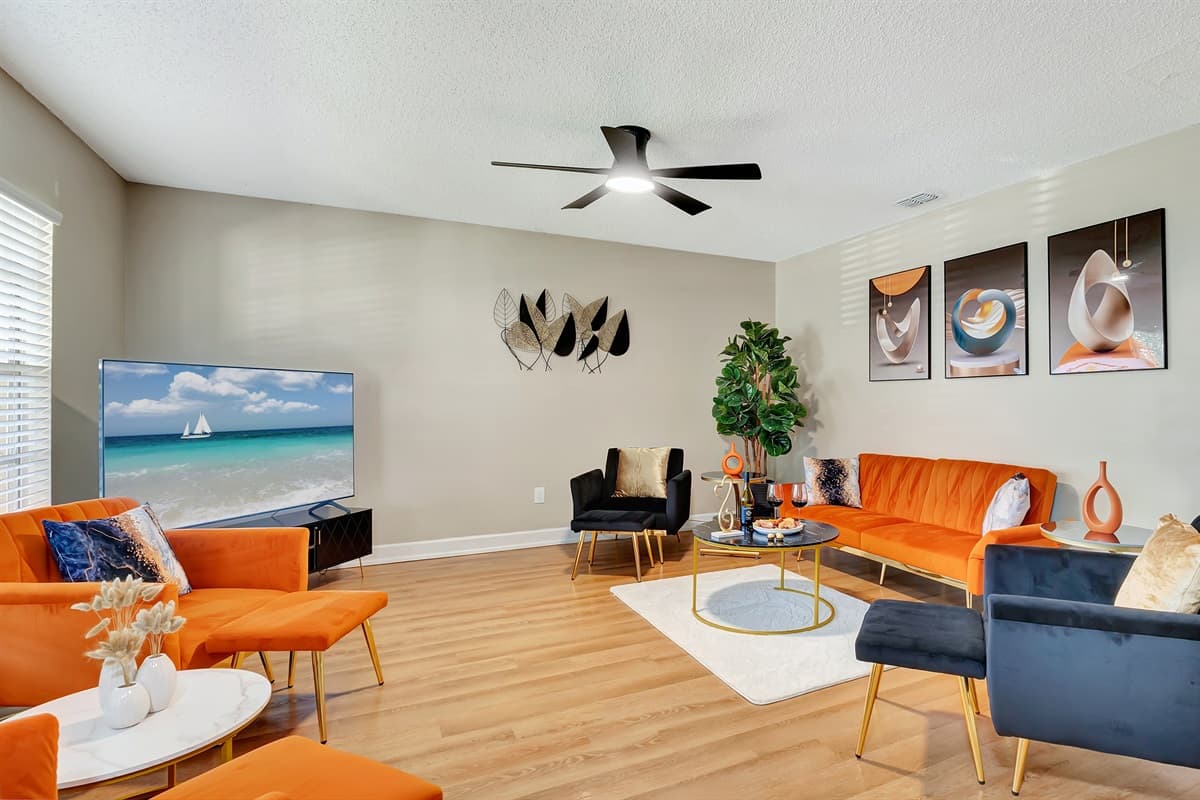 Sink into our plush, oversized sofas and armchairs, all tastefully upholstered in a chic combination of bright orange and navy blue that adds a pop of energy to the room.