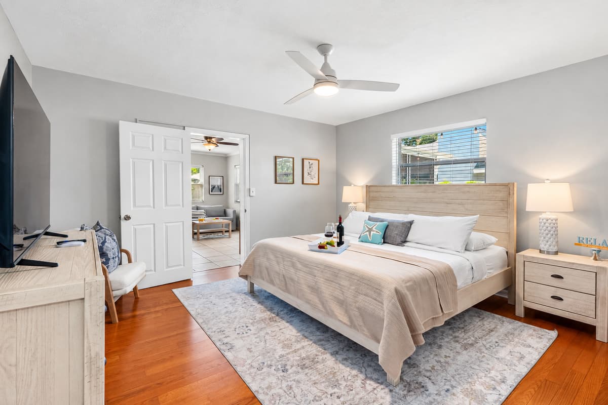 Coastal elegance meets comfort in this serene master suite with a king bed, soft textures, and soothing tones.