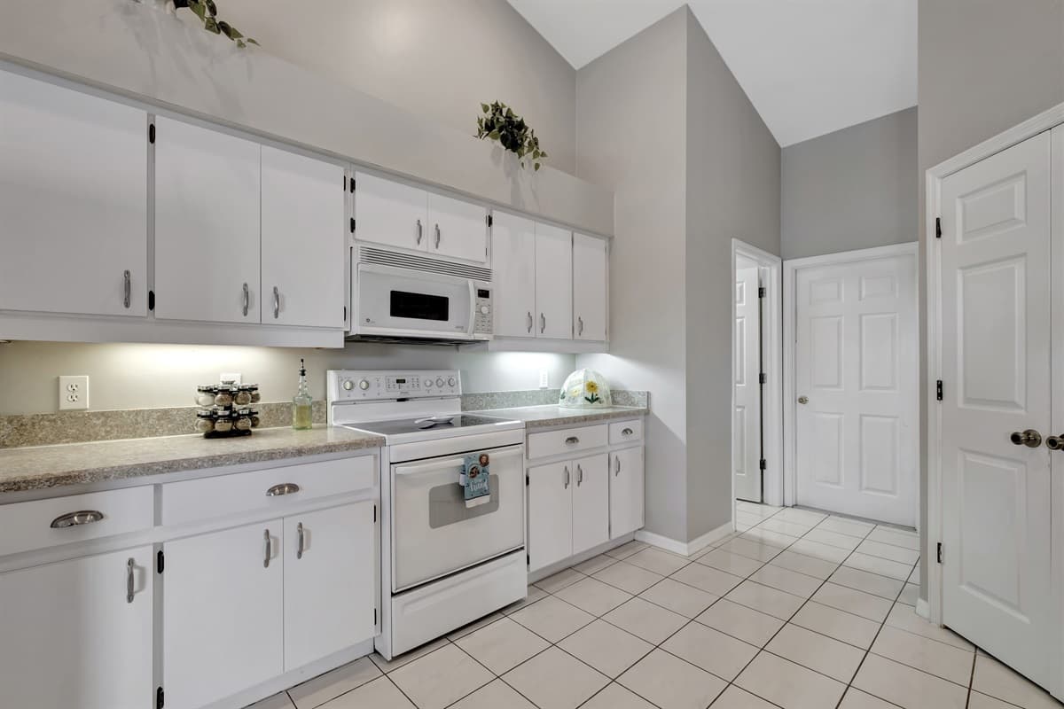 Come and experience the allure of our kitchen, where the white wooden cabinets, gleaming appliances, complete utensils, and the light-filled ambiance create an atmosphere that is both captivating and inspiring. 