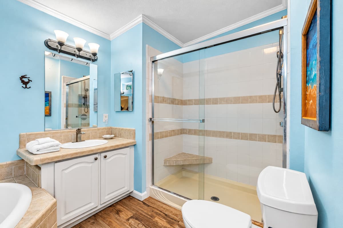 A glass-enclosed shower-tub combo offers convenience and style, perfect for relaxing after a day of adventure.