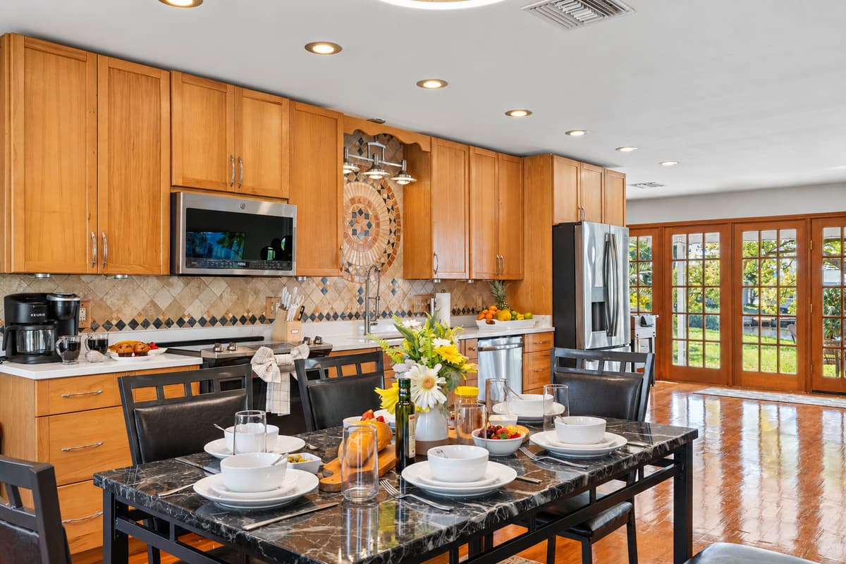 This kitchen showcases beautiful natural wood cabinetry paired with modern stainless steel appliances, offering both charm and functionality.
