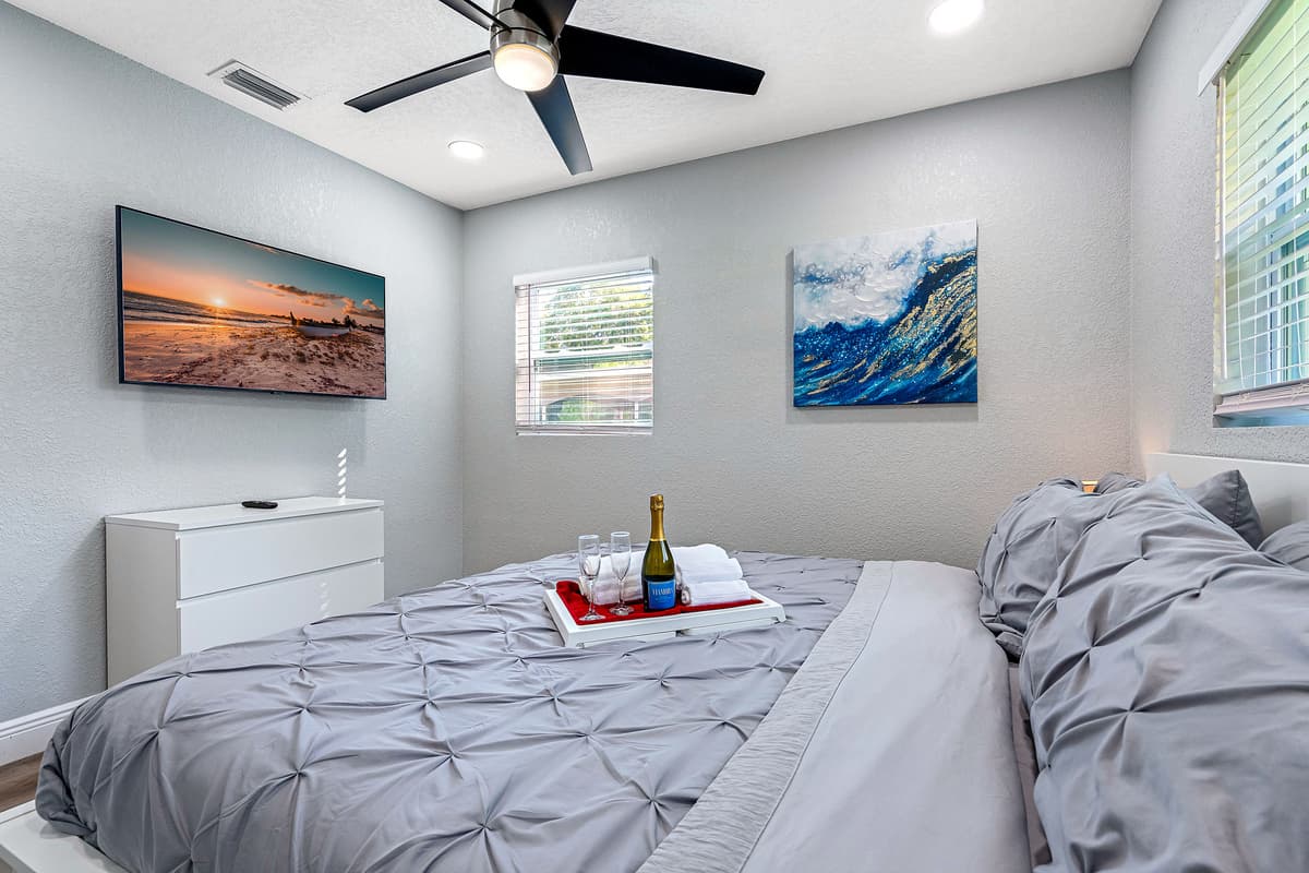 This comfortable bedroom has a king-size bed, full length mirror closet, and its own TV. Who wouldn't want a comfortable room to rest in after a long day at the beach?