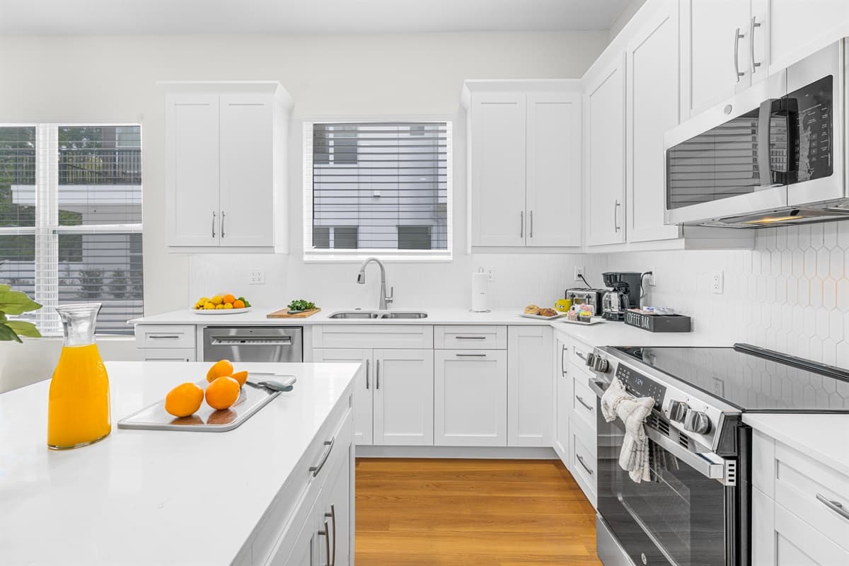 Natural light pours through the kitchen window over a deep sink — washing up is a breeze.