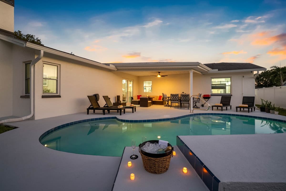 The combination of warm evening light and modern pool illumination makes this backyard an ideal spot for relaxation and connection — day or night.