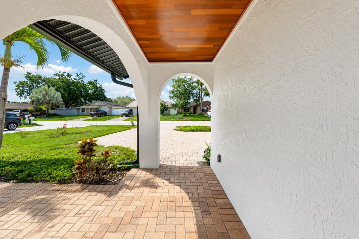 Covered front porch offering shade and a welcoming space to arrive and depart comfortably throughout your stay.