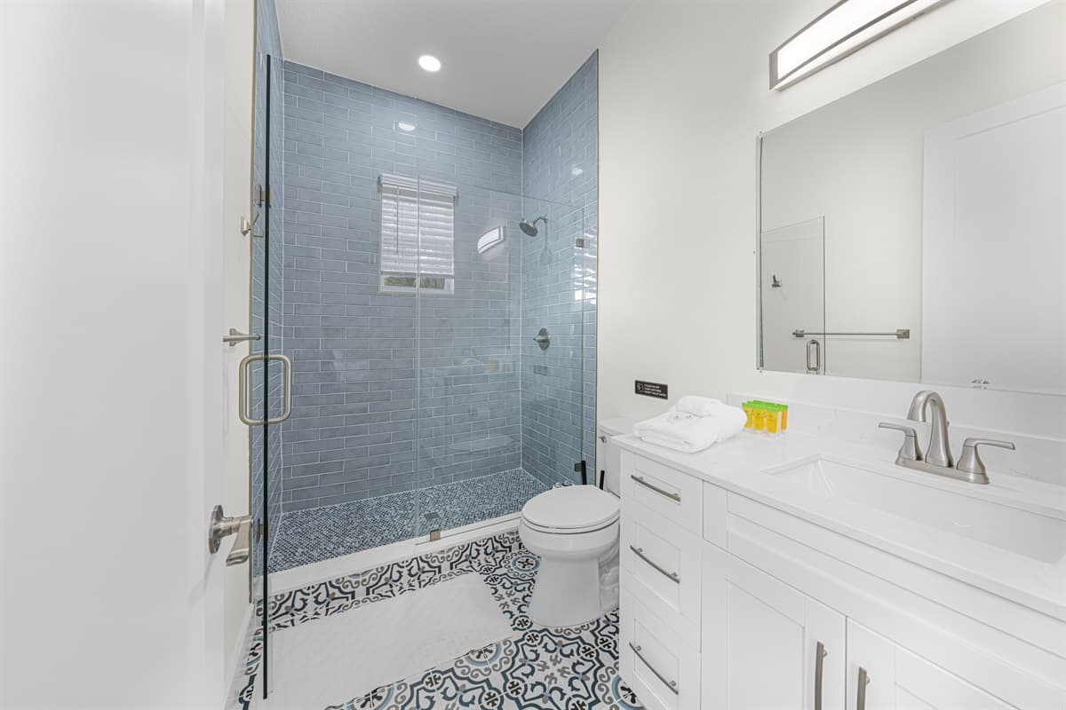 Stylish bathroom with glass walk-in shower and contemporary design.