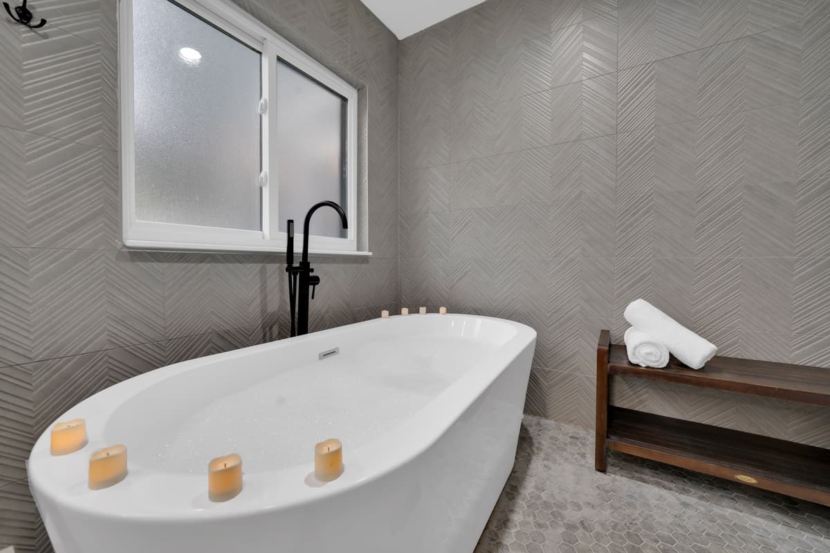 Candles by the tub say more than any amenity list could: someone thought about what "relaxing" actually looks like here.