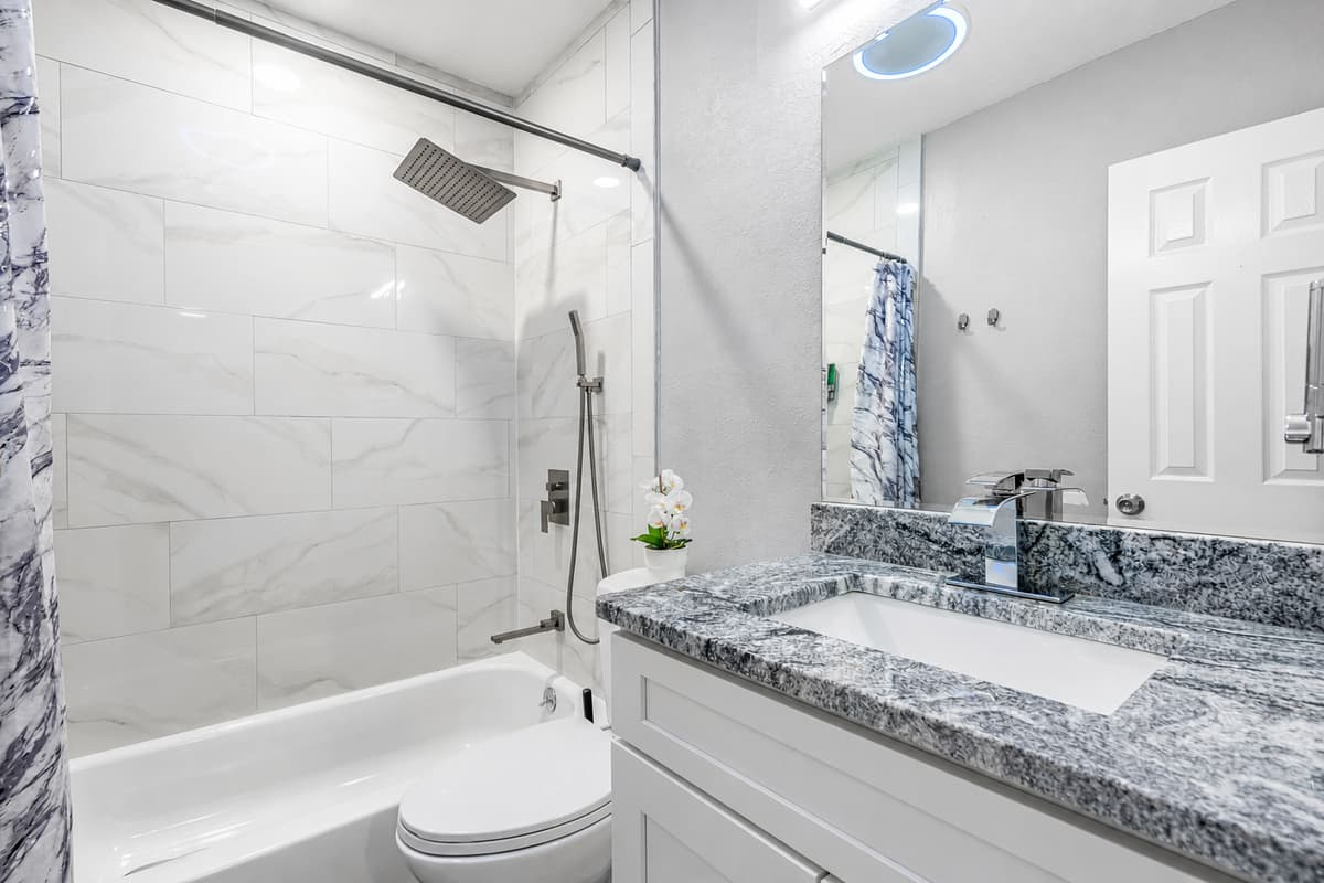 Beautiful bathroom equipped with bathtub, sink, toilet and shower. Enjoy a relaxing bath after a long day of travel from your home to your home away from home. If you think this property if for you, send us an inquiry right away!