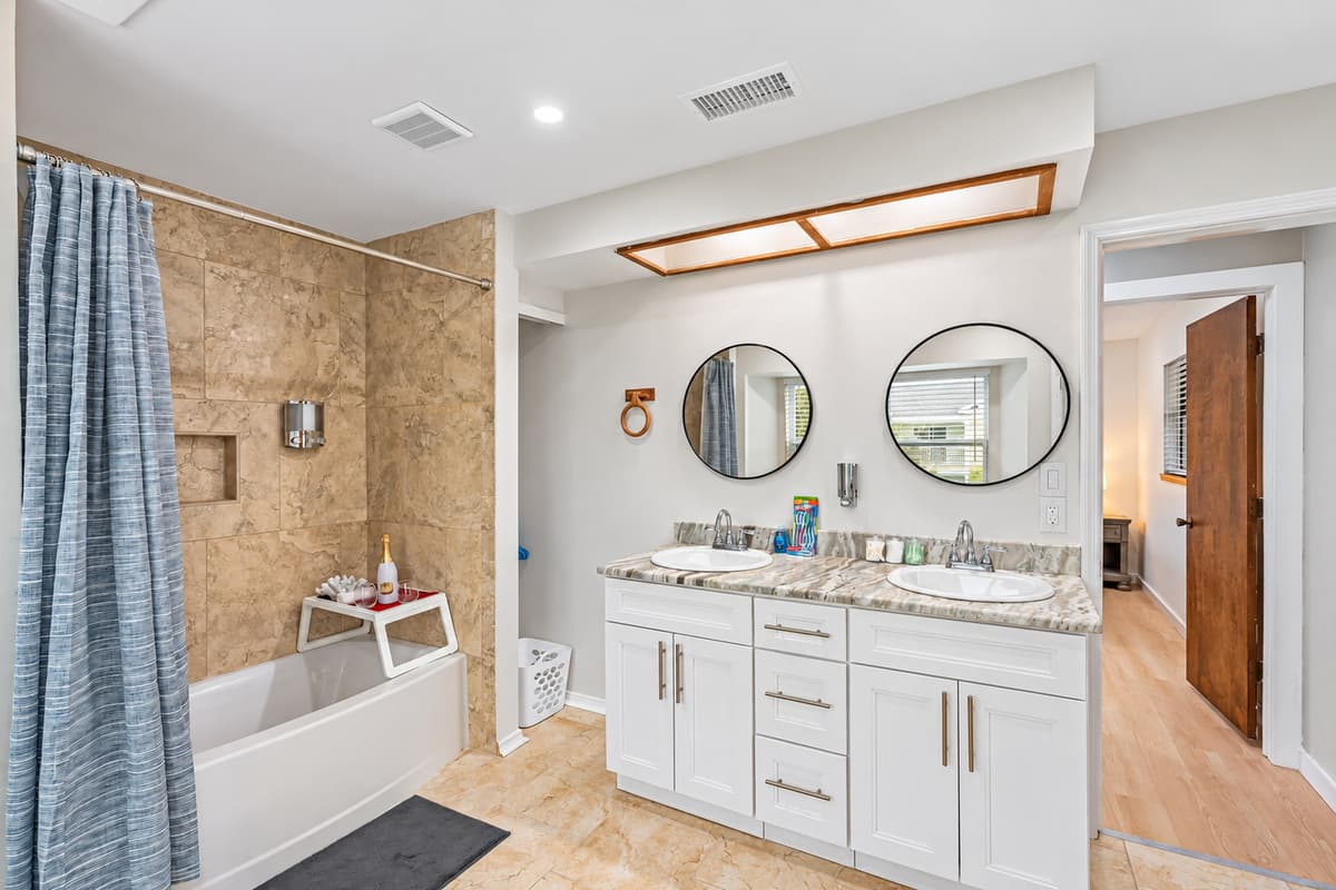 The centerpiece of the space is the inviting tub and shower combination, offering the best of both worlds.