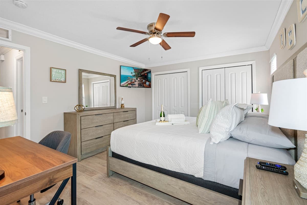 The bed's cozy ambiance is complemented by a stylish dresser, providing ample storage space for your belongings and adding a touch of sophistication to the room.
