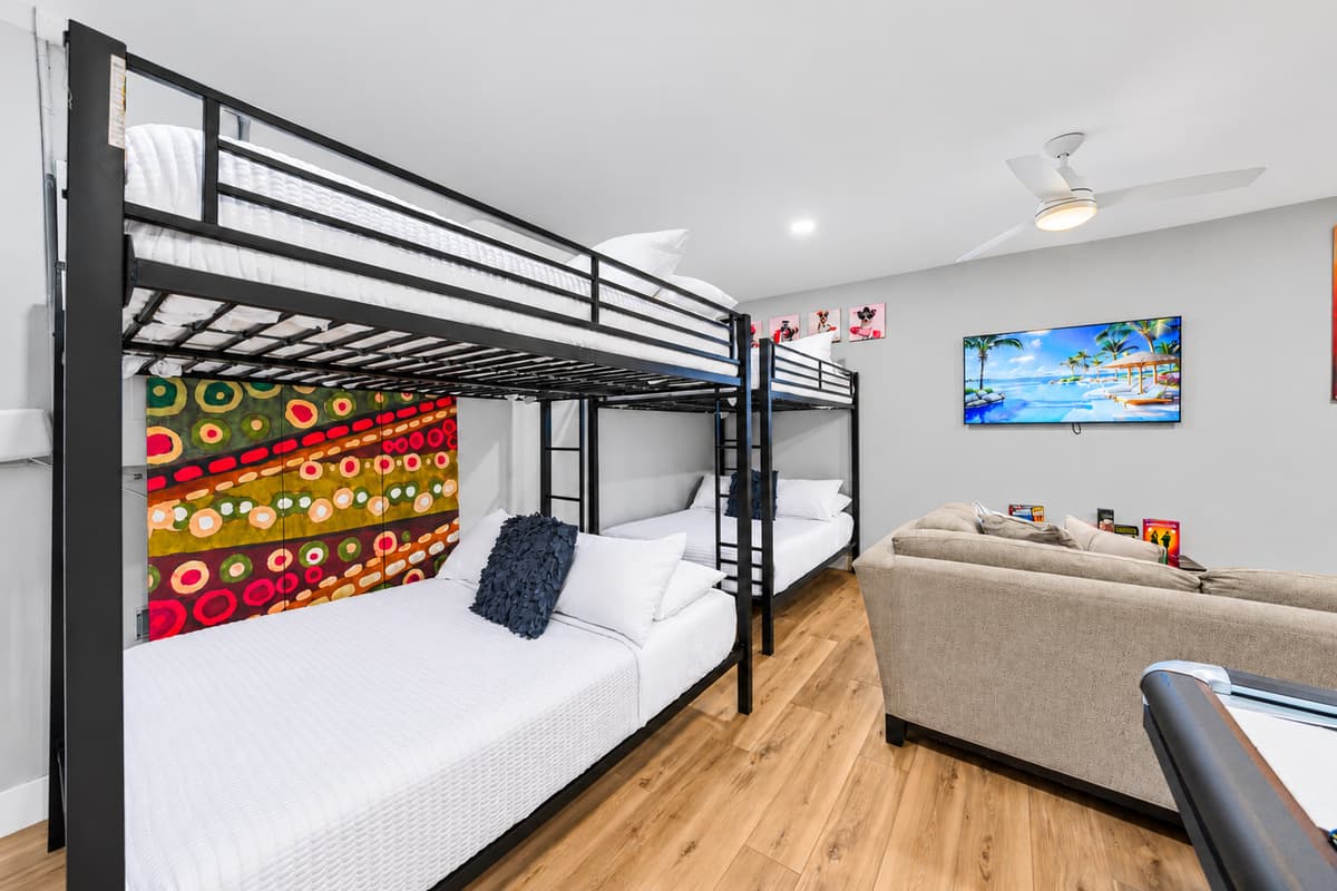 Bunk beds offer comfortable sleeping accommodations right next to the entertainment area.