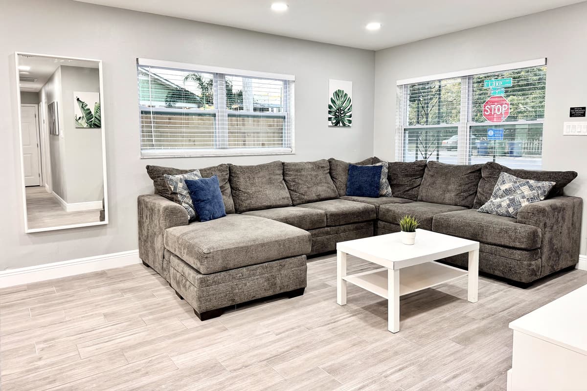 Upholstered in soft, durable fabric and accented with cozy throw pillows, the sofa invites you to kick back and relax.